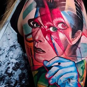 Tattoo David bowie on the upper arm motif: colorful style: surrealistic