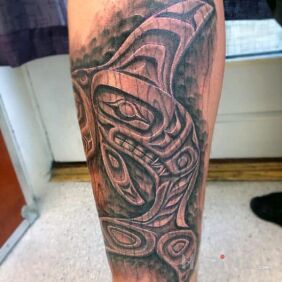 Tattoo Wooden dolphin on the calf motif: black and gray style: carved wood