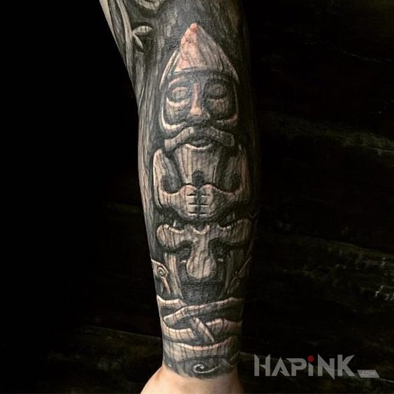 Tattoo Dziadek in black and gray motif and carved wood style on the forearm