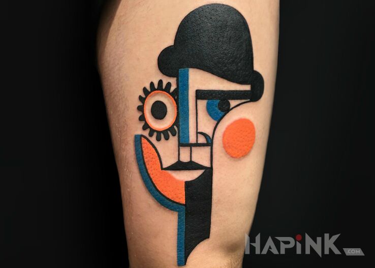 Tattoo Pan z kapeluszem in colorful motif and modern / cubism style on the leg