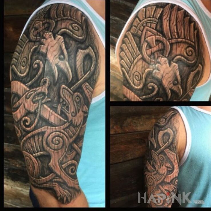 Tattoo Orzeł walczący z wilkiem in black and gray motif and carved wood style on the upper arm