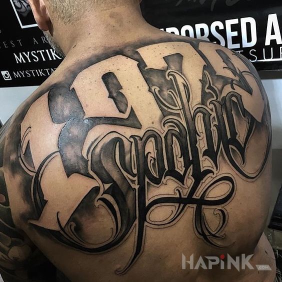 Tattoo 1970 spanic in black and gray motif and calligraphy style on the back