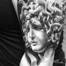 Tattoo Sad Medusa on the upper arm motif: characters