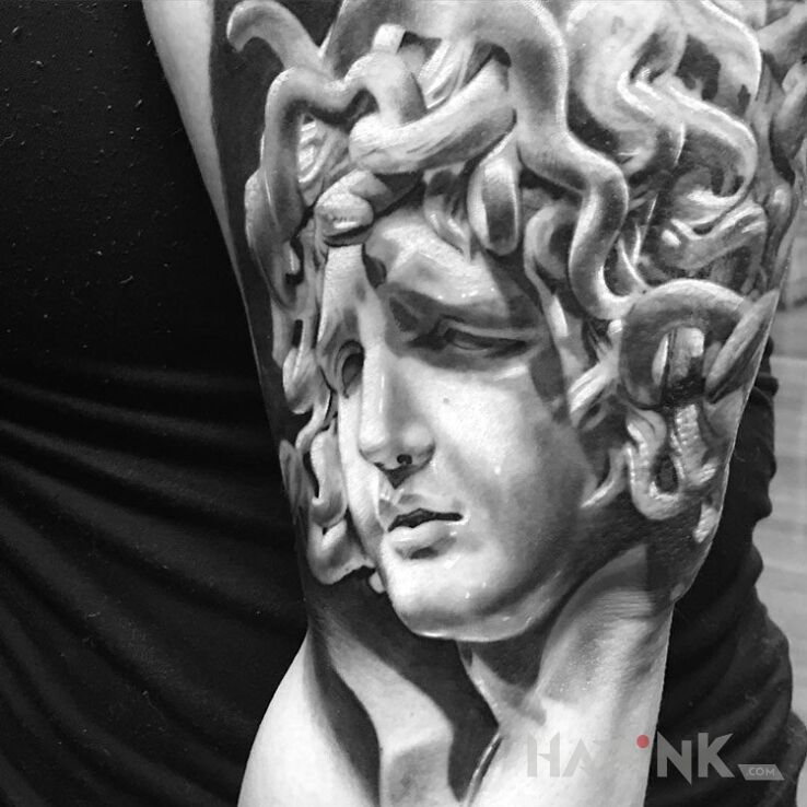 Tattoo Smutna Meduza in characters motif on the upper arm
