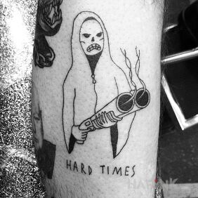 Tattoo Hard Times on the forearm motif: lettering style: ignorant