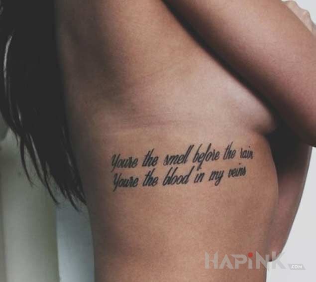 Tattoo Milosne wyznanie in lettering motif and calligraphy style on the ribs