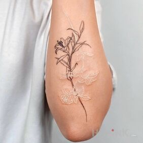 Tattoo White and black flower on the forearm motif: flowers style: graphic / illustrative