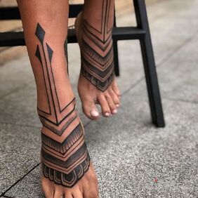 Tattoo Little feet on the tibia motif: other style: graphic / illustrative