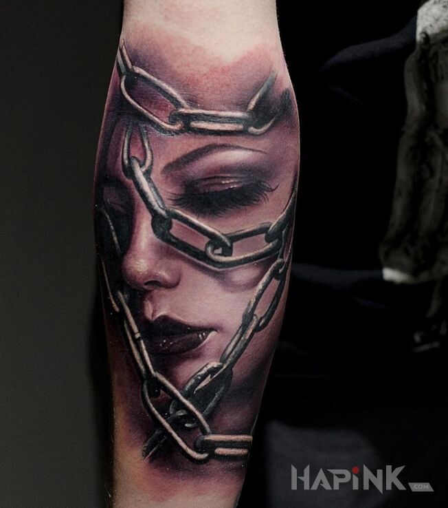 Tattoo Uwięziona in characters motif and realistic style on the forearm
