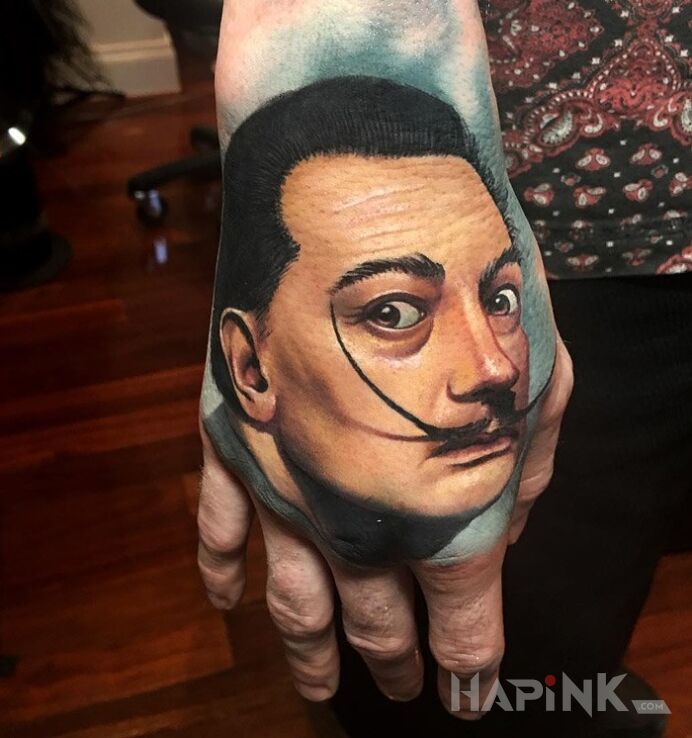 Tattoo Salvador dali in characters motif and realistic style on the hand