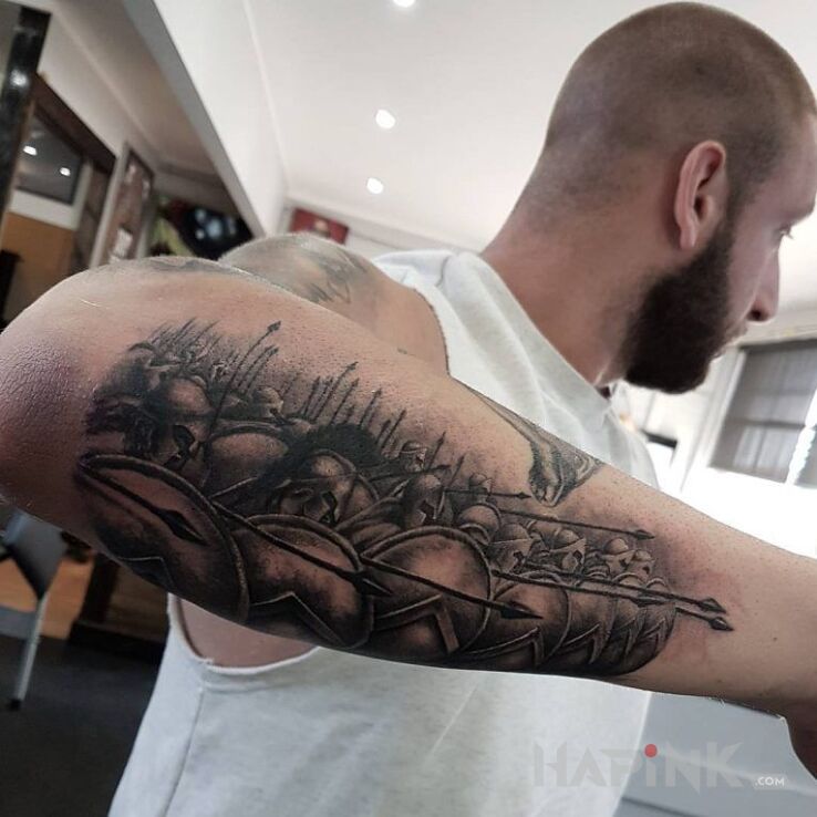 Tattoo 300 gotowi do obrony in black and gray motif and realistic style on the forearm
