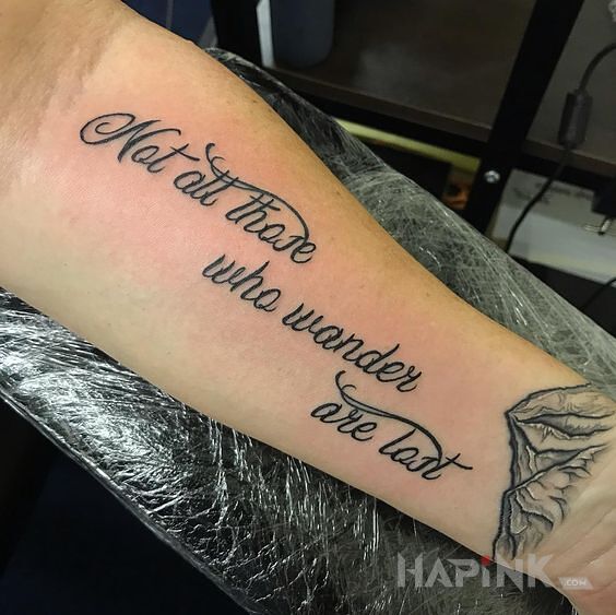 Tattoo Przyjemny napis in lettering motif and calligraphy style on the forearm