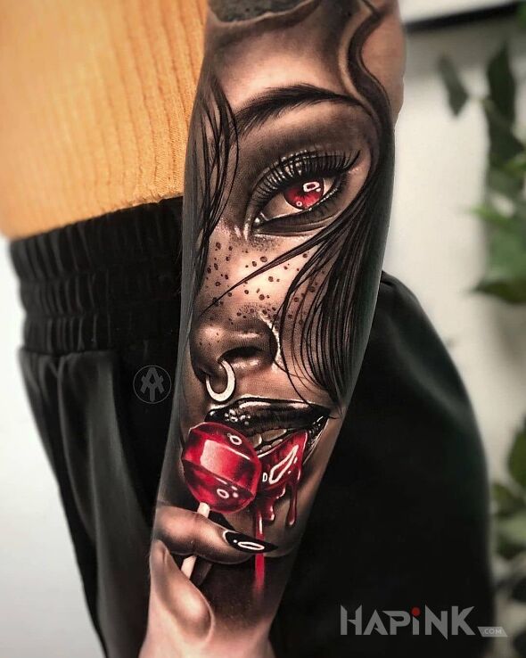 Tattoo Czerwony lizak in black and gray motif and realistic style on the forearm
