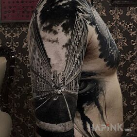 Tattoo On the street on the upper arm motif: black and gray style: realistic