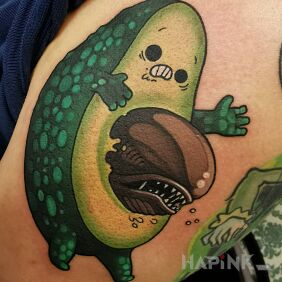 Tattoo Alien avocado ? on the upper arm motif: characters style: graphic / illustrative