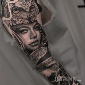 Tattoo Girl with an owl on her head ? on the upper arm motif: animals style: realistic