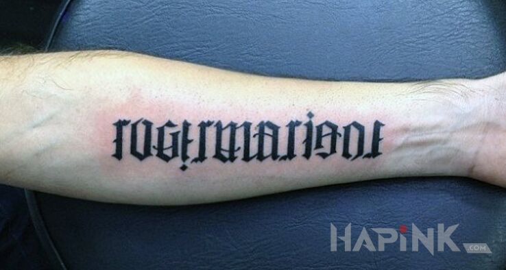 Tattoo Kto przeczyta? in lettering motif and ambigrams style on the forearm