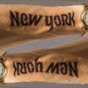 Tattoo New York / Rich Man on the forearm motif: lettering style: ambigrams