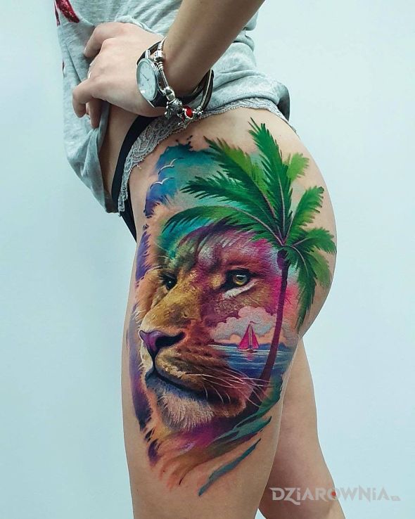 Tatuaż lew pod palmą w motywie zwierzęta i stylu realistyczne na nodze