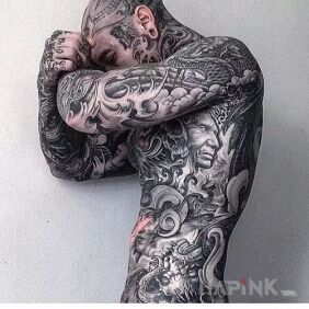 Tattoo All covered in ink on the upper arm motif: faces style: realistic