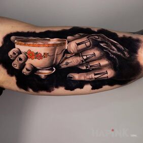 Tattoo Ink cup on the upper arm motif: lettering style: realistic