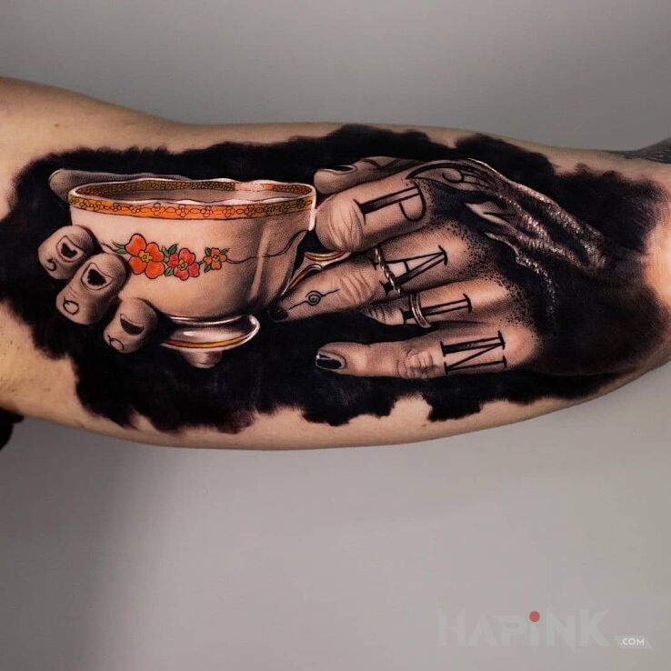 Tattoo Filiżanka tuszu in colorful motif and realistic style on the upper arm