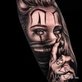 Tattoo Girl in a scarf on the forearm motif: black and gray style: chicano