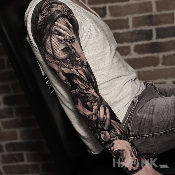 Tattoo Facepalm in black and gray motif and realistic style on the upper arm