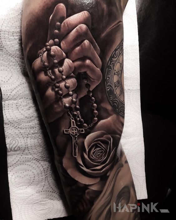 Tattoo Różaniec i modlitwa in black and gray motif and realistic style on the upper arm