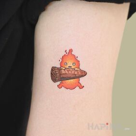Tattoo Little flame on the upper arm motif: characters style: cartoon / comic book