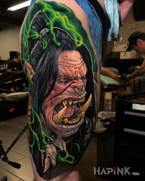 Tattoo World of Warcraft in colorful motif and realistic style on the leg