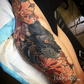 Tattoo Black panther on the leg motif: flowers style: japanese / irezumi