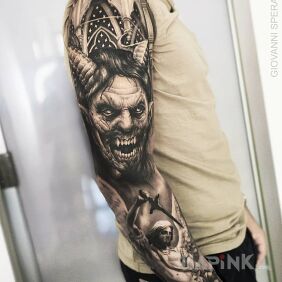 Tattoo Devil incarnate on the upper arm motif: black and gray style: realistic