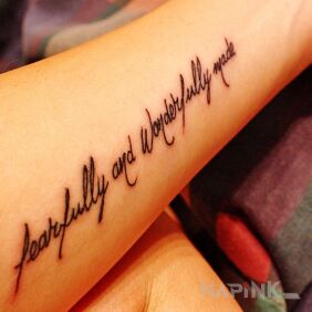 Tattoo Fearfully and wonderfully made on the leg motif: lettering