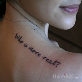Tattoo Who is more real? on the back motif: lettering