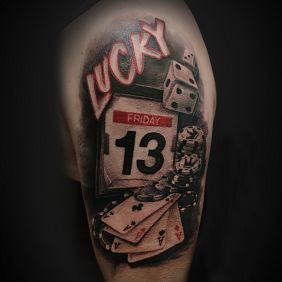 Tattoo Friday the 13th on the upper arm motif: colorful style: realistic