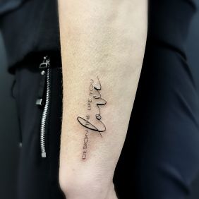 Tattoo Sentence on the forearm motif: lettering style: calligraphy