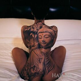 Tattoo Buddha on the back motif: black and gray style: realistic