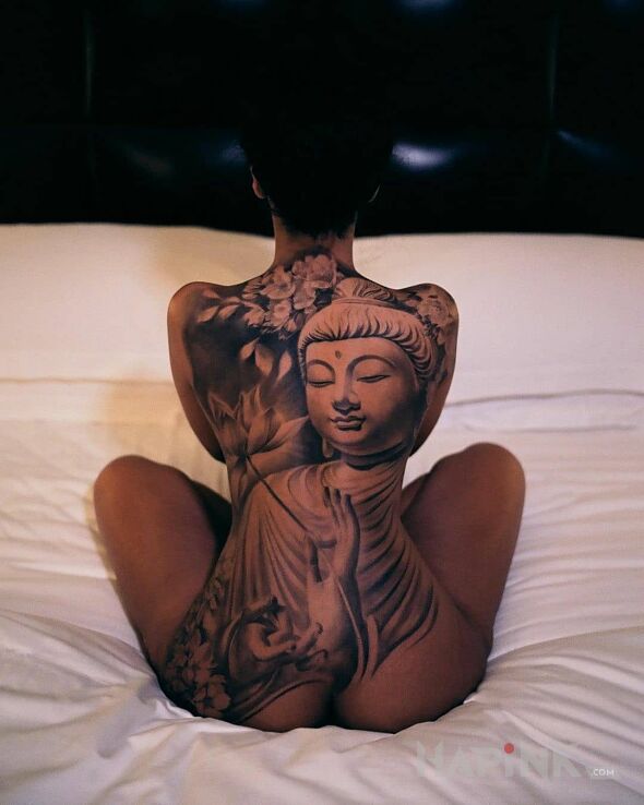 Tattoo Budda in faces motif and realistic style on the shoulder blades