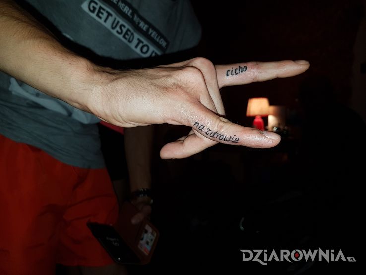 Tatuaż na palcach w motywie napisy na palcach