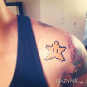 Tattoo Star from Mario on the upper arm motif: pixelated