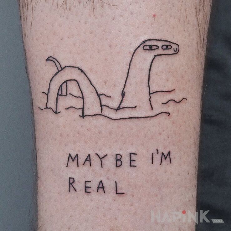Tattoo Potwór z lochness in lettering motif and ignorant style on the calf