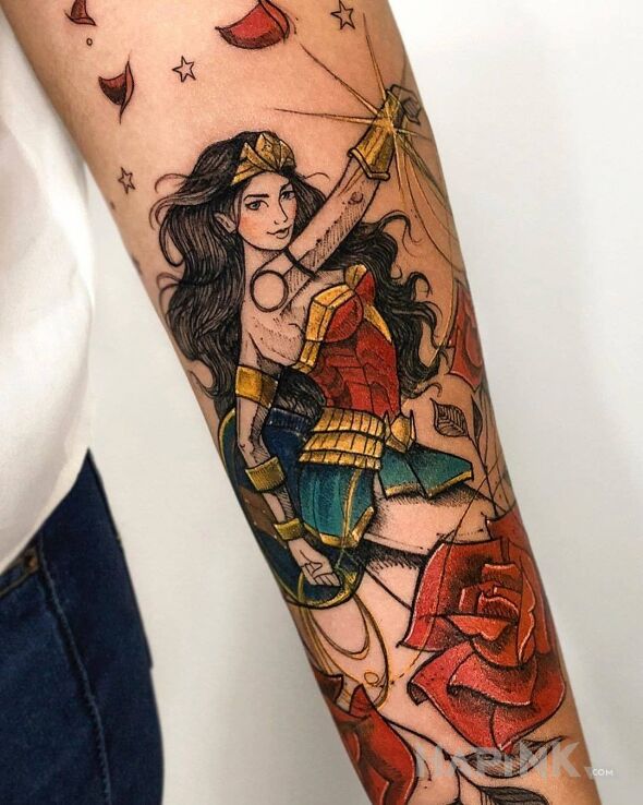 Tattoo Wonder Woman in flowers motif and graphic / illustrative style on the forearm