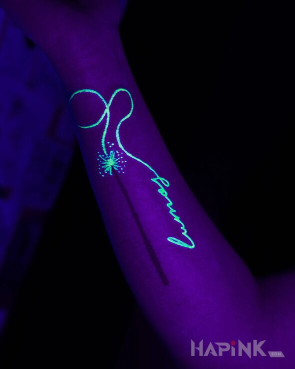 Tattoo Magiczna rozdzka in glow in the dark motif on the forearm