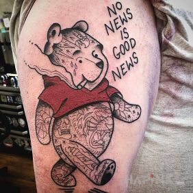 Tattoo No news is good news on the upper arm motif: lettering style: graphic / illustrative