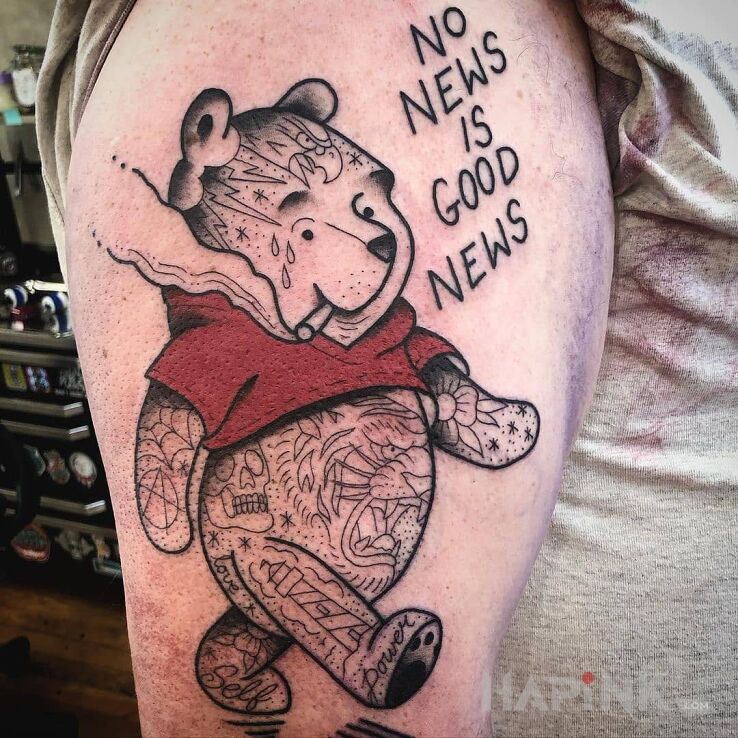 Tattoo No news is good news in lettering motif and graphic / illustrative style on the upper arm