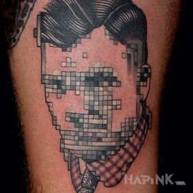 Tattoo Blurred face on the upper arm motif: pixelated style: graphic / illustrative
