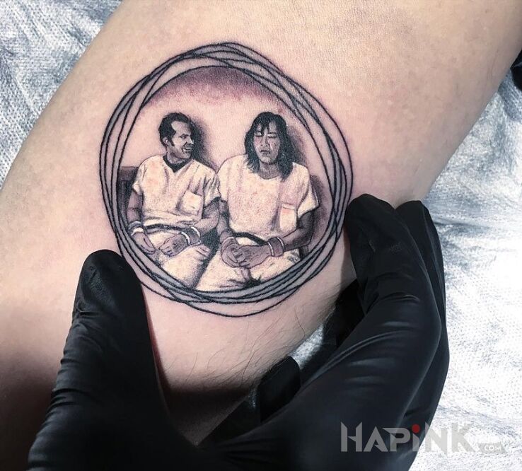 Tattoo Scena z filmu in characters motif on the forearm