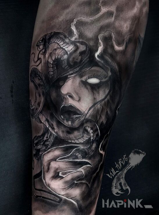 Tattoo Meduza in faces motif and realistic style on the forearm
