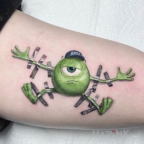 Tattoo Monsters, Inc. on the upper arm motif: colorful style: cartoon / comic book